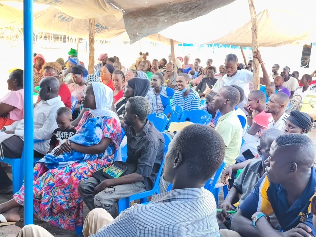 Children at Light Academy in Kalobeyei receiving educational learning materials and community support