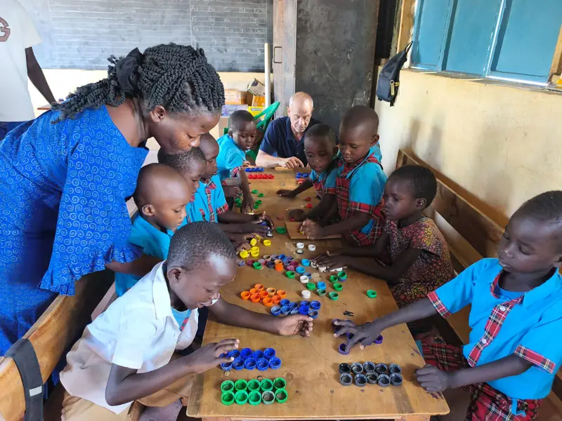Children building with puzzle pieces around a table