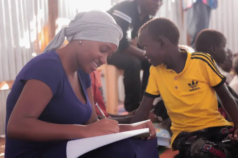 An adult giving one-to-one writing support to a pupil